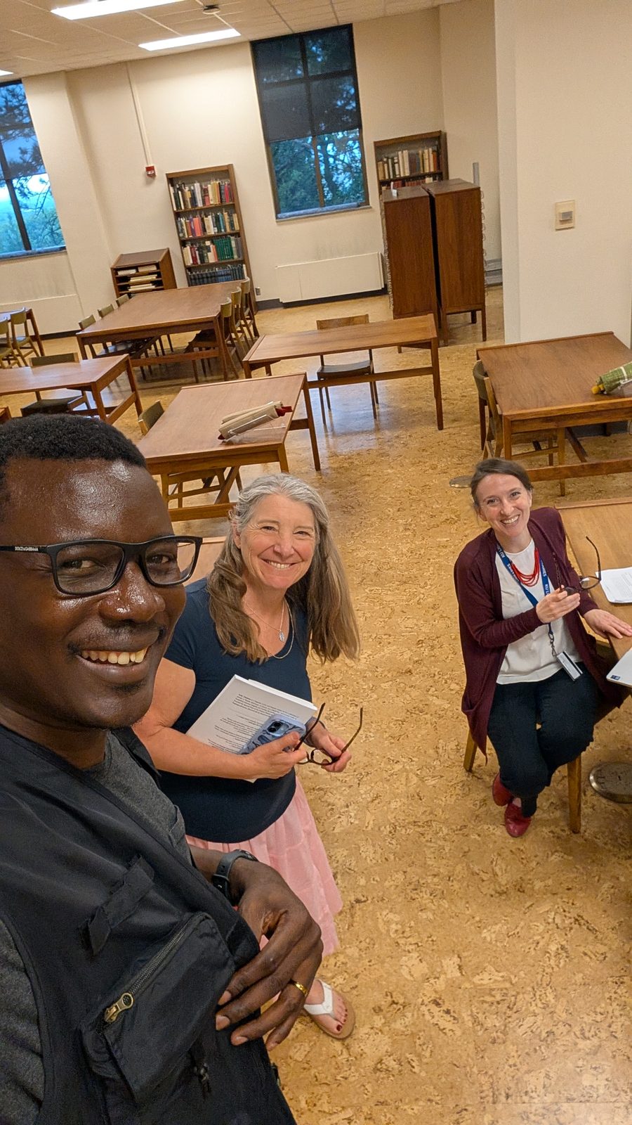 Kọ́lá Túbọ̀sún with two librarians in the reading room of the Kenneth Spencer Research Library