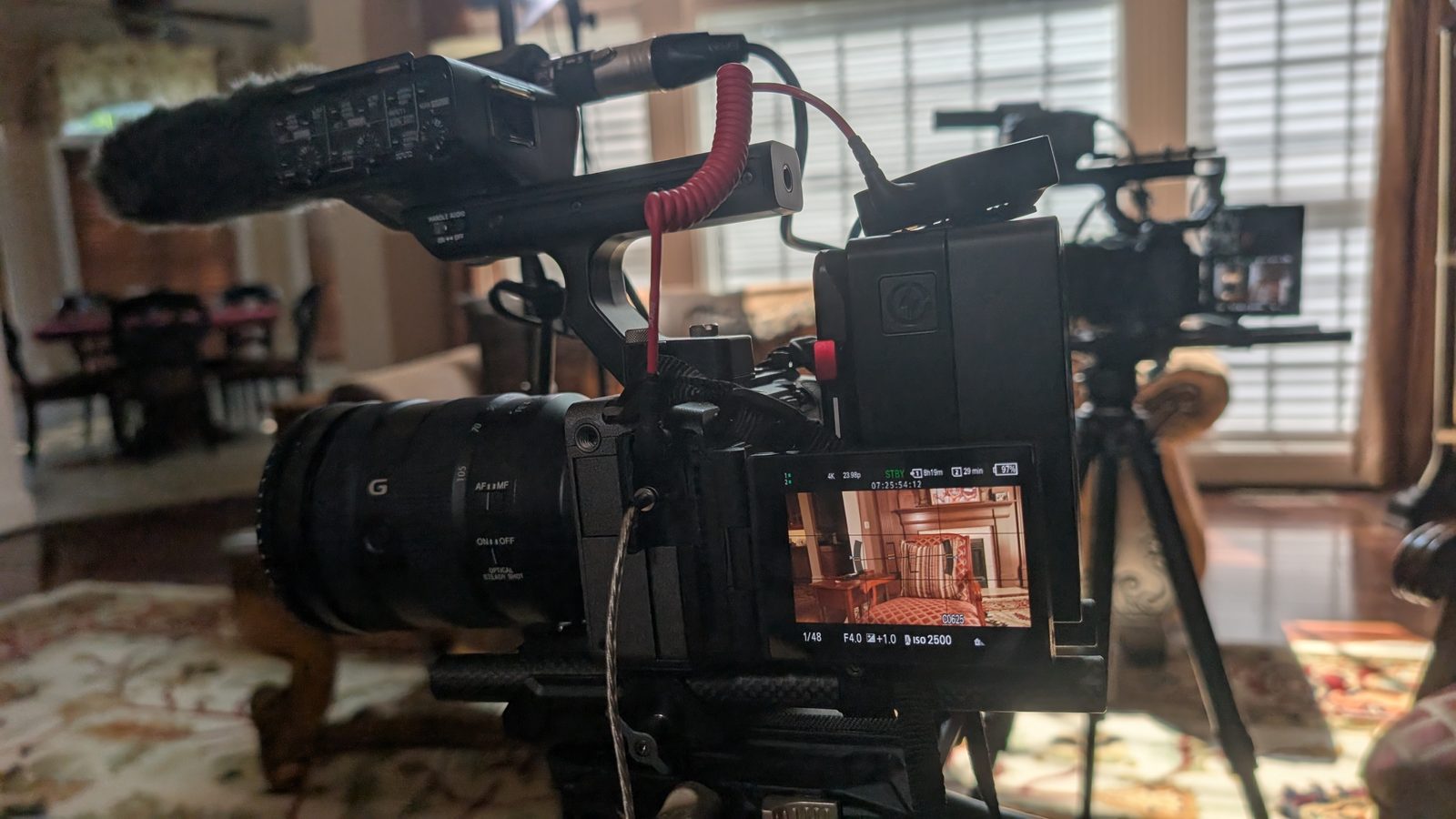 Camera rig with shotgun microphone and monitor set up in a domestic interior